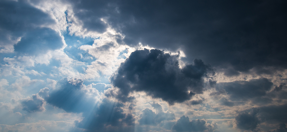 Sun breaking through dark clouds