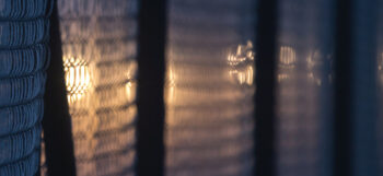 Light shining through a fence
