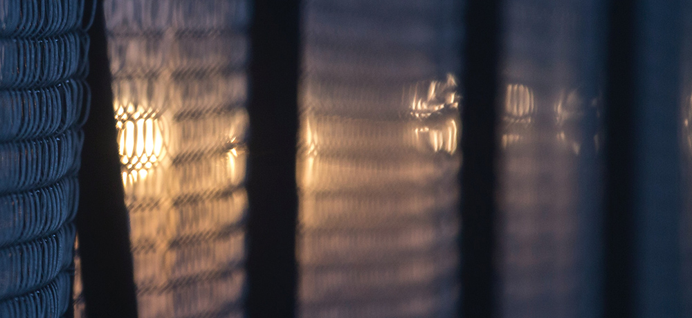 Light shining through a fence