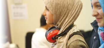Teenage girls with headphones smiling