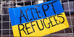 Blue and yellow sign saying "accept refugees"